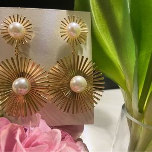 Beautiful long party earrings with gold color finish and Pearl in the middle.